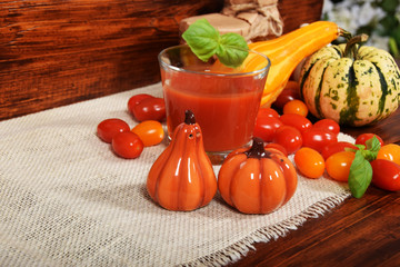 healthy tomato juice with basil made of sweet cocktail tomatoes and pumpkin and pumpkin salt containers with free space for text