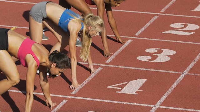 Three female athletes simultaneously start running marathon, rivalry, slow-mo