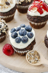 Muffins decorated with fresh fruits and oatmeal flakes