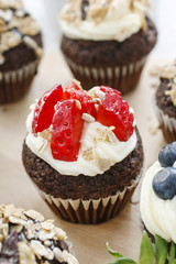 Muffins decorated with fresh fruits and oatmeal flakes