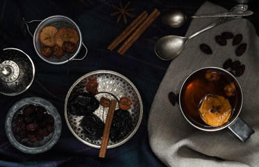 Various nuts and dried fruits in metal dishes on the table. Top view