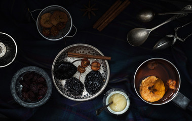 Various nuts and dried fruits in metal dishes on the table. Top view