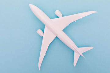 White plane on light blue background. Top view