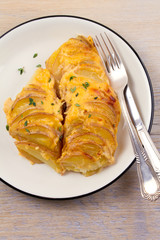 Potato gratin. Baked potato slices with creamy sauce. vertical