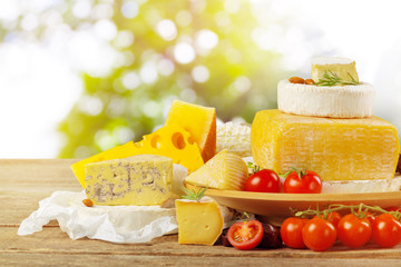 Tasty beautiful cheese composition on wooden board