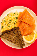 Smoked Salmon and Scrambled Eggs With Rye Bread and Lemon Breakfast