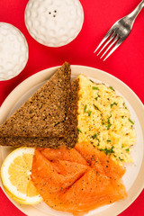 Smoked Salmon and Scrambled Eggs With Rye Bread and Lemon Breakfast