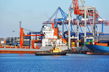 Tugboat assisting bulk cargo ship