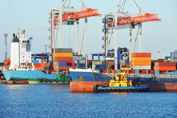 Tugboat assisting bulk cargo ship