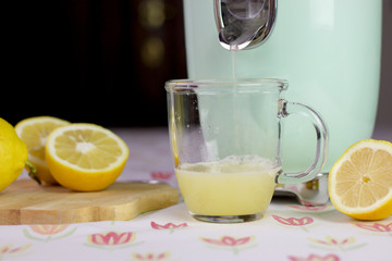 fresh lemon juice comes out from the citrus  squeezer