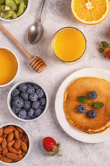 Obraz na płótnie Canvas Pancakes with fruit, honey, nuts.