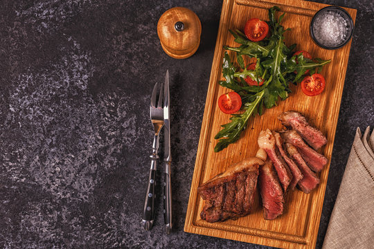 Beef steak on a dark background.