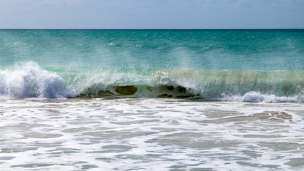 Waves breaking at the sand beach shore