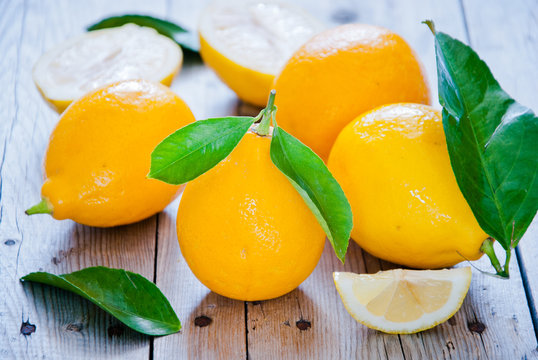 Fresh organic lemons on gray wooden table