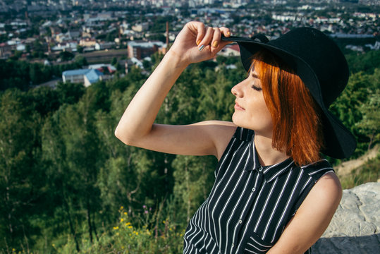portrait of pretty young woman on the top of the hill