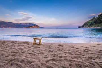 Evening view from small Mogren Beach with Island of Saint Nicholas in Budva, Montenegro