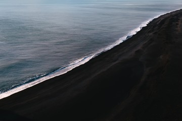 graphic and geometric photo of the black sand beaches in Vik Iceland - obrazy, fototapety, plakaty