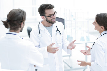 Medical staff discuss in a modern hospital room