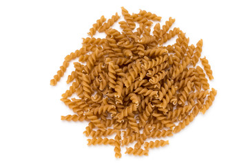 Uncooked wholemeal pasta isolated white background.