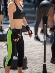 Naklejka premium Fitness and Exercising Concept: Girls Workout with Speed Ball and Free Standing Boxing Punch Bag