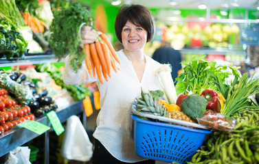 Mature woman buying fresh vegetables