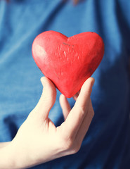 Heart in girl's hands, close up