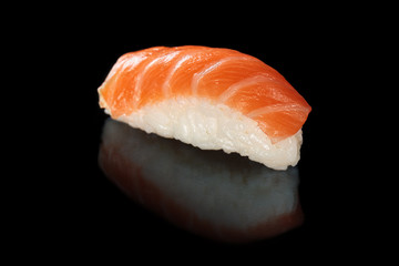 Salmon sushi on black.