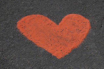 Heart made of red sand on a dark background.Creative declaration of love, symbol of love.Valentine's Day or Love concept.