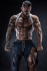 Fototapeta na wymiar portrait of strong Athletic Fitness man showing big muscles