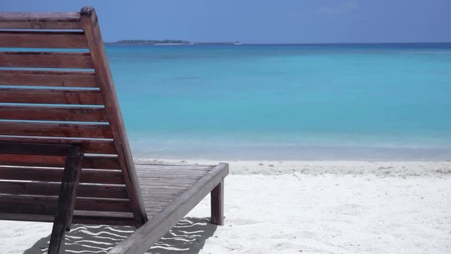 One wooden sunbed on tropical calm beach