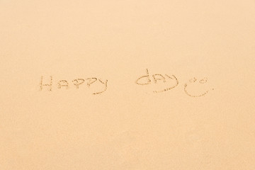 Handwritten Happy day in the sand on the beach
