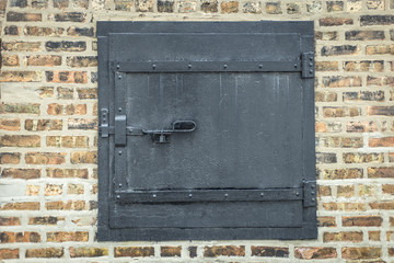 Locked black door on brick wall