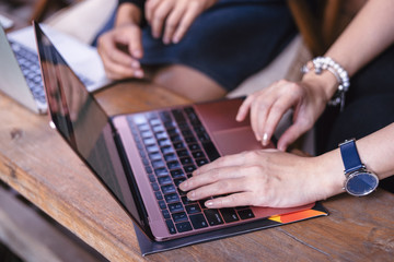Women hand working on computer notebook in coffee shop