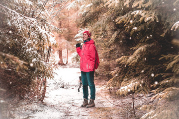 Girl walking in winter wonderland fairytale forest
