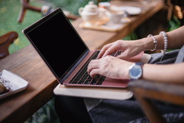 Women hand working on computer notebook in coffee shop