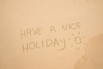 Handwritten Have a nice holiday in the sand on the beach