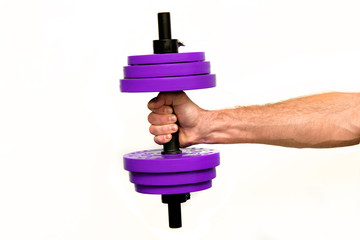 A man's hand holds a dumbbell of purple on a white isolated background