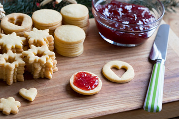 Preparation of Linzer Christmas cookies - filling the cookies with jam