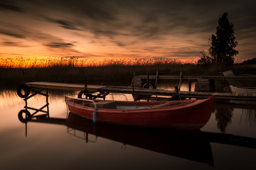 Red boat in sunset