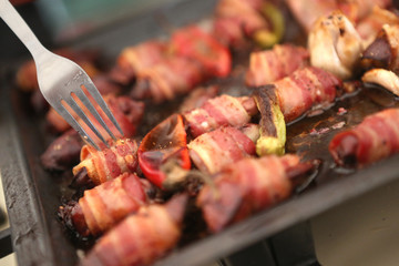 Sausages wrapped with fried bacon