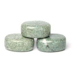 Three greenish polished jadeite stones for spa massage isolated on white background