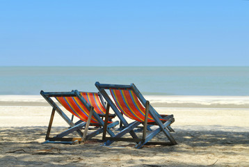 Fototapeta na wymiar wooden beach chair at the beach