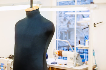 Close up male sew mannequin on talor working place. The concept of sewing production. Selective...