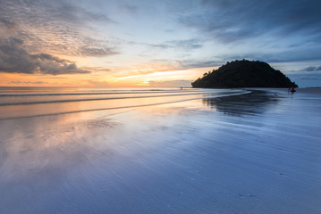 Fototapeta na wymiar Sunset seascape with reflection at Kelambu Beach, Sabah Malaysia.