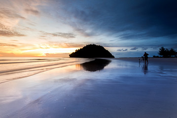 Sunset seascape with reflection at Kelambu Beach, Sabah Malaysia.