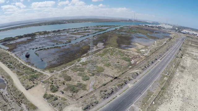 Drone footage of remote industrial area near power station and high-voltage towers, taken at Outer Harbor, Port Adelaide, South Australia.