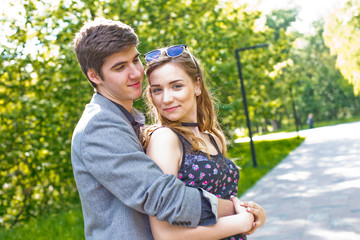 Naklejka premium The guy hugs a girl from behind.