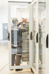 Electrician engineer tests electrical installations on relay protection system
