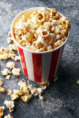 Cinema concept with popcorn in red white bag