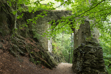 The stone gate in the forest with path © Jiri